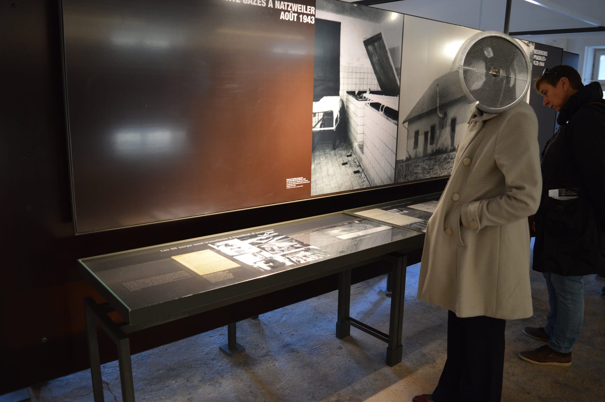 Visitors reading an exhibit at a history museum in Europe