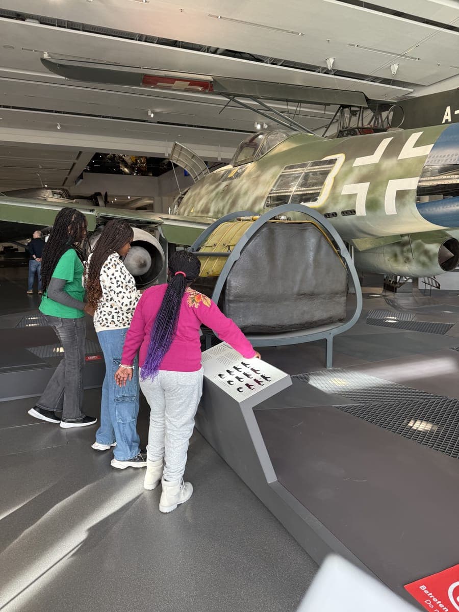 Students exploring an aircraft exhibit at a science museum in Europe