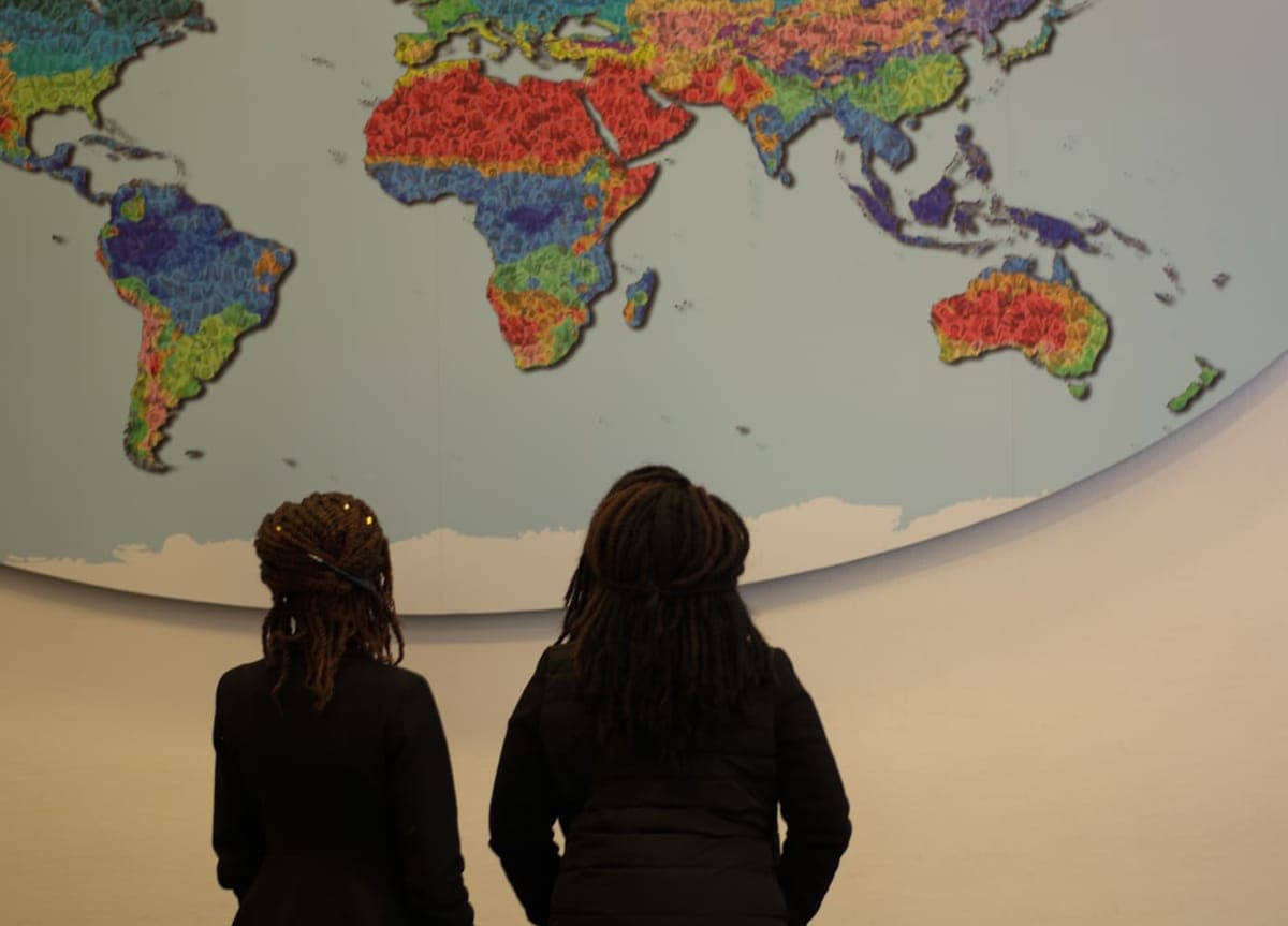 Kenyan law students studying a world map on a study visit in the Netherlands